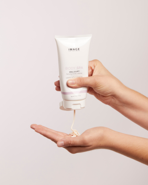 A woman pouring IMAGE BODY SPA CELL.U.LIFT® firming body crème