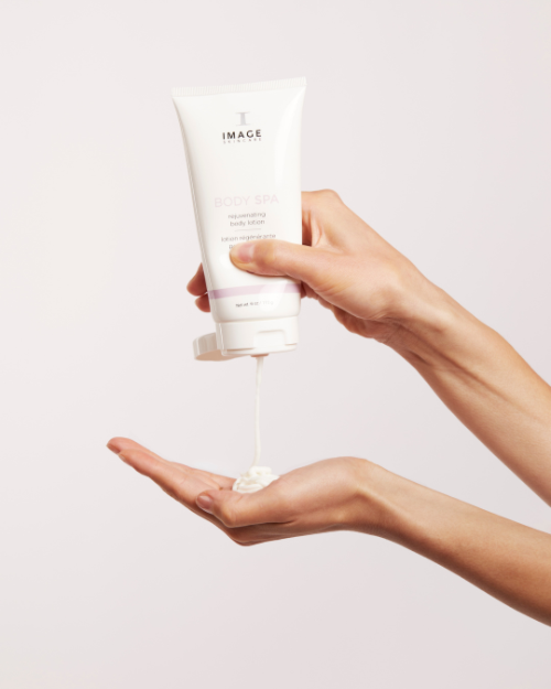 A woman pouring IMAGE BODY SPA rejuvenating body lotion