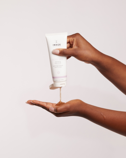 A woman is pouring IMAGE BODY SPA exfoliating body scrub