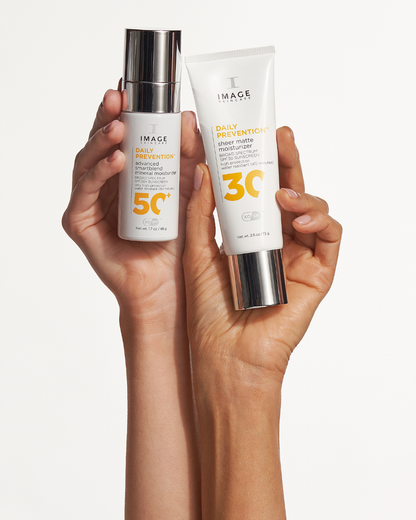 Hands holding IMAGE Skincare DAILY PREVENTION Sheer Matte Moisturizer SPF 30