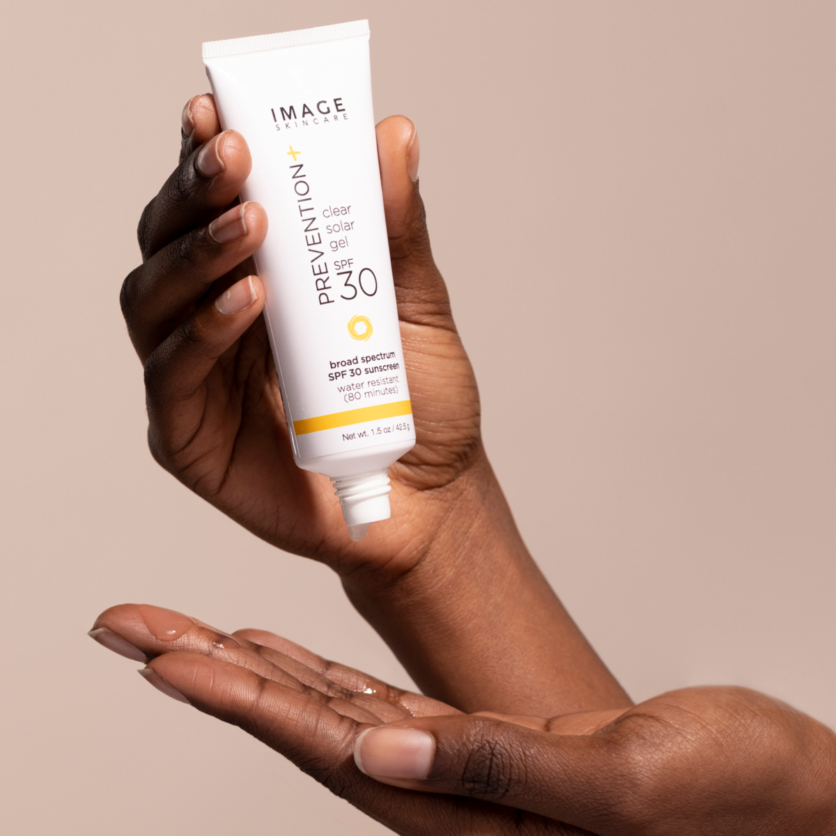 Pouring IMAGE Skincare PREVENTION+ clear solar gel SPF 30 on a hand