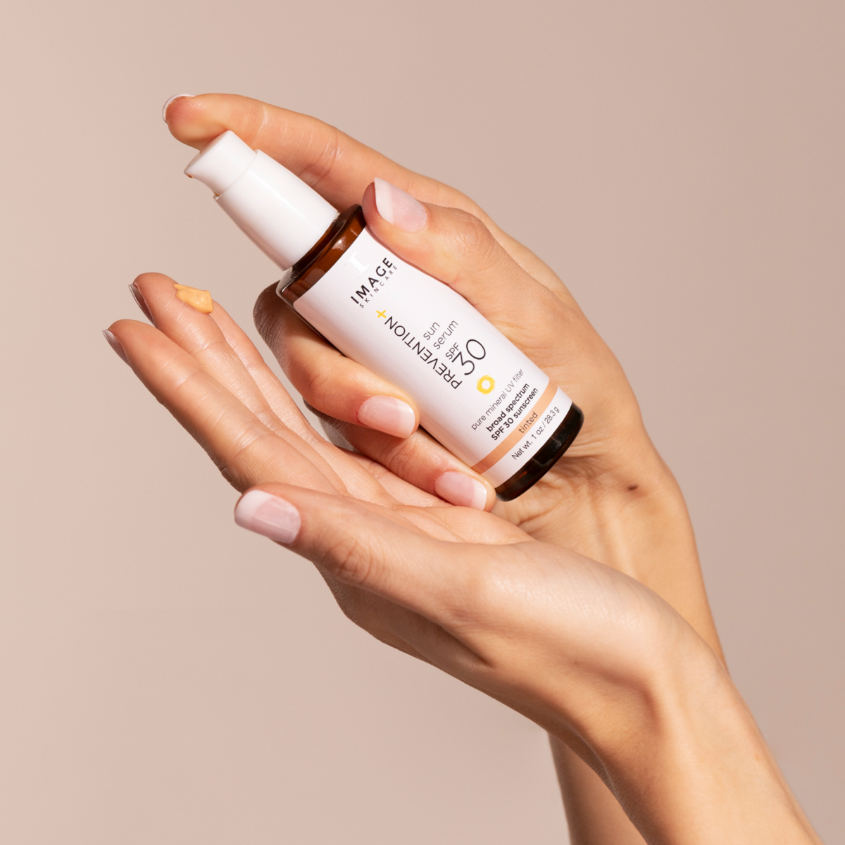 IMAGE Skincare PREVENTION+ sun serum SPF 30 tinted sample on a hand