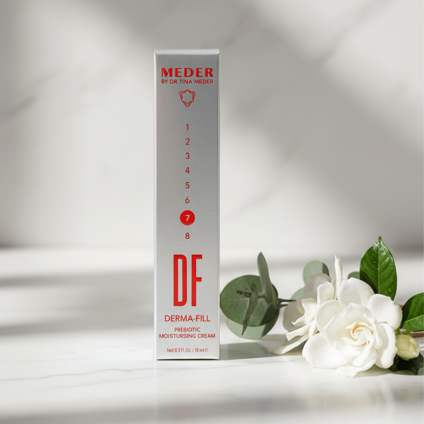 MEDER Derma-Fill travel size moisturising cream box styled with a white gardenia flower