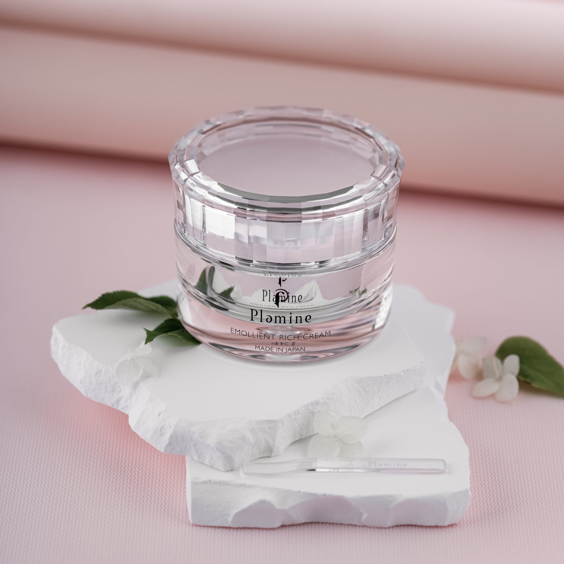 Plamine Emollient Rich Cream on light background, beauty studio shelf