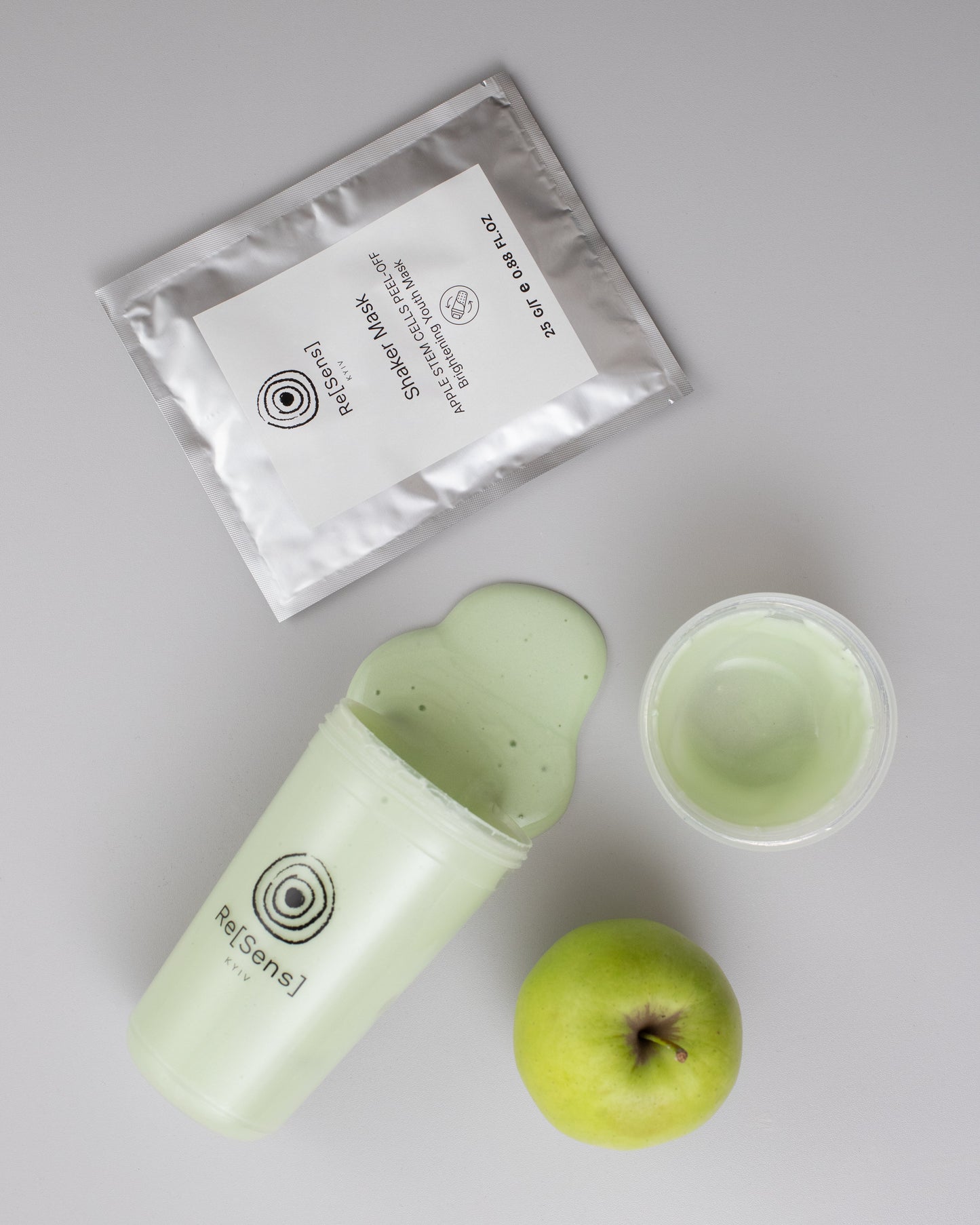 Re[Sens] Apple Stem Cells Peel-Off Shaker Mask alginate paste, shaker and a green apple flat lay